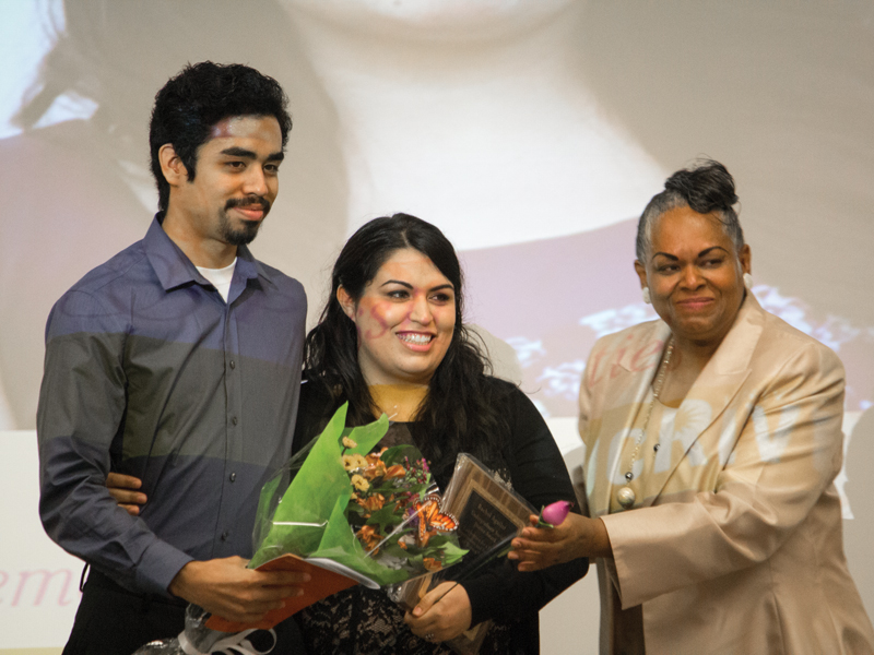 Social Justice Award honoree, Rachel Aguilar, receives flowers from her presenter Roberto Corella, and Director of Women's Resource Center, Adrienne Sims. Courtesy of Jie Huang