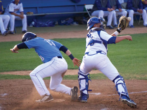 Ryan Lillie (No. 36) nearly misses the tag to get the runner out at home.