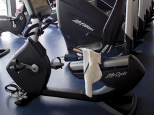 A towel is left forgotten on one of the cardio machines.