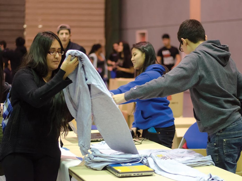 ASPB volunteers hand out sweaters to students after checking their ID.