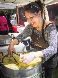 One of the festival attendees packaging a chicken tamale for a hungry customer