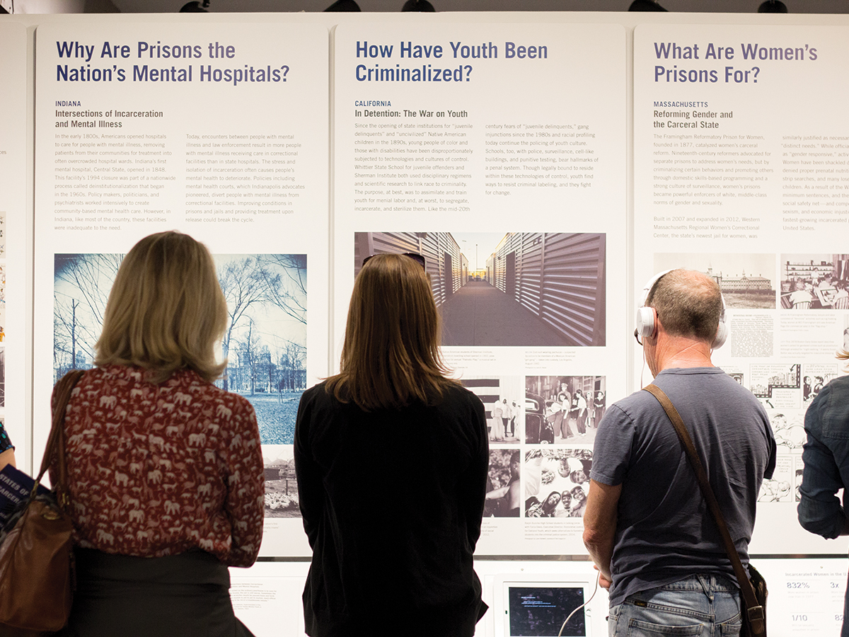 Members of the Riverside community read and examine the states of incarceration exhibits. Jaspery Goh/HIGHLANDER