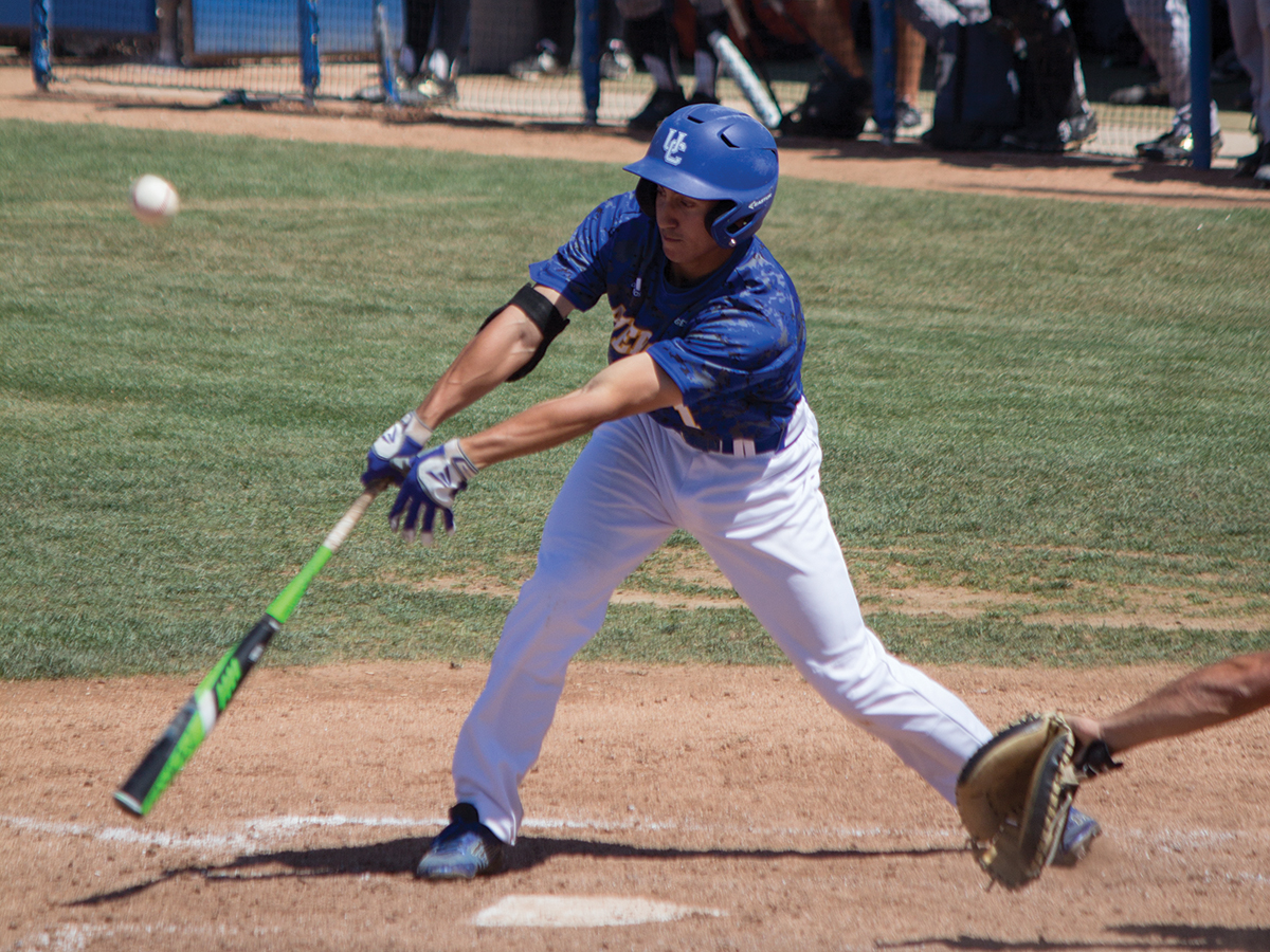 Austin Colvin (No. 4) swings at the ball.