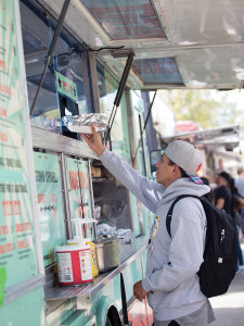 A student picks up his hot dog from Dogtown Dogs.