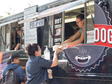 A student picks up her lunch from Grill-A-Dog food truck.