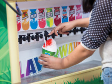 A student customizes her shaved ice at the Kona Ice food truck.