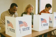 Diverse individuals voting together.